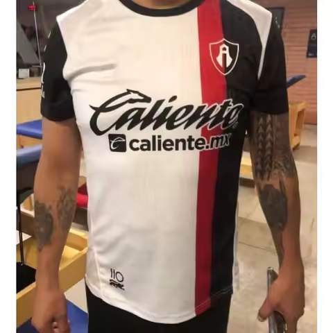 Men Atlas Soccer Jersey Black White Vertical Split Red Stripe Crew Neck Caliente Caliente.mx Sponsor