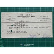 old cheque with stamp behind. First Commercial Bank