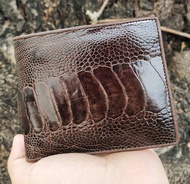 The wallet is made of ostrich leather in tamarind brown color.