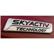 Embossed - Skyactiv Technology Logo Is Stuck Behind Mazda 3 Car