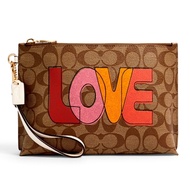 กระเป๋าคลัทช์ COACH C2890 ROWAN POUCH IN SIGNATURE CANVAS WITH LOVE PRINT (IMLOT)