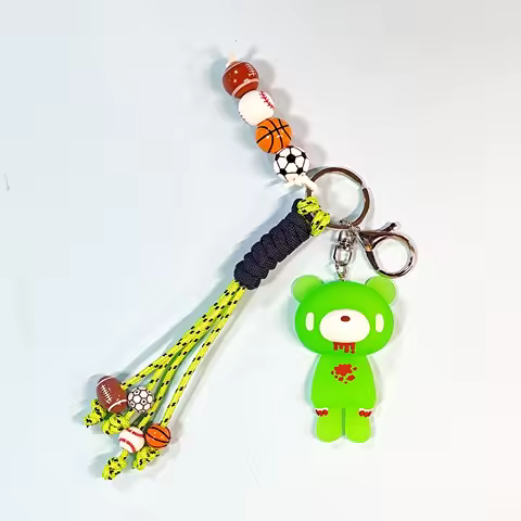 Gloomy Bear keychain. Bright green bear, sports - themed beads & tassel. Fun for bags/keys.