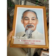 Picture of Uncle Ho on the wall, classroom size, blue background, red background, gold frame, antiqu