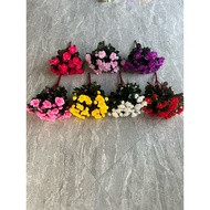 Decorative artificial flower azalea cluster.