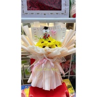 Bouquet of wax sunflowers with graduation bears as a meaningful gift
