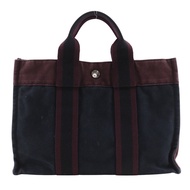 二手愛馬仕 Fourre Tout PM 手提包，黑色/紅色棉質布料，A5 型按扣開合。男女通用。