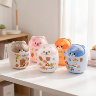 The compact trash bin features a flip lid and cute bear design, perfect for desk use.  Tong sampah m