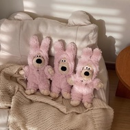 Dog stuffed animal wearing a bewildered pink rabbit outfit