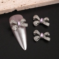 AC.906 Thai Shop Retail 1 Piece Silver Nail Accessories Bow Shape Decorated With Purple Diamonds