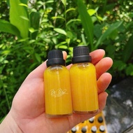Glass bottle containing Ginger Shot 30ml-50ml in a plastic cap containing ginger shot, essential oil