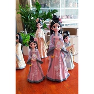 Purple-clothed lady doll holding a fan