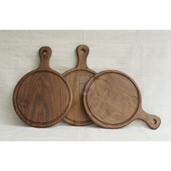 Walnut wood round cutting board with slotted handle