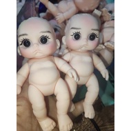 5ink Doll with black eyes and sad face made up