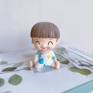 Brown-haired boy holding a milk bottle