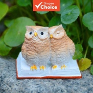 Double owl reading resin figurine, presenting the image of two owls perched atop books, exudes an au