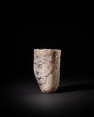 A pale jade 'pine trunk' rhyton, Qing dynasty, Qianlong period | 清乾隆 清白玉蒼松紋首盃