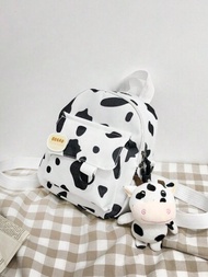 Una encantadora mochila ligera de gran capacidad con patrón de vaca dibujos animados con colores blanco y negro, adecuada para niños y niñas, viene con una pequeña insignia, ideal para viajar o utilizar en la escuela