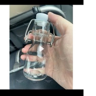 Odd glass bottle containing GINGER SHOT