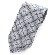 GUCCI 100% 絲質領帶，飾有 GG 標誌印花，常規尺寸，銀色和海軍藍配色，成色極佳。義大利製造。正品。推薦男士佩戴。