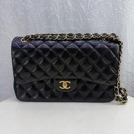 This is a Chanel Classic Double Flap bag in black leather with gold-tone hardware