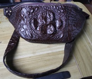 Carry it in style with this tamarind brown genuine crocodile leather chest bag.