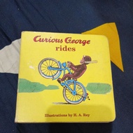 Curious George rides illustration by H.A. Rey board book