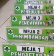papan nama akrilik segitiga di meja