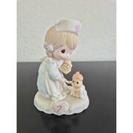 Precious Moments growing in grace age 7 girl dressed as a nurse feeding syrup to an ill cat