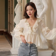 LUCA STUDIO_Erika Blouse - เสื้อผ้าเรยอนสีครีม แขนยาว แต่งระบาย คอวี ริบบิ้นไขว้ผูกโบว์กลางอก