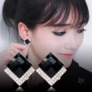 Black minimalist cold-weather earrings popular this year, studded with geometric rhombus shapes, evo
