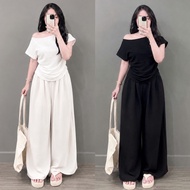 Women's big size off-the-shoulder shirt in foam fabric combined with high-waisted pants to cover the