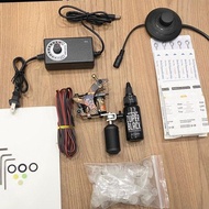 Set of 1 tattoo machine with 1 tattoo ink on human skin