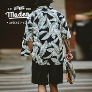 MADEN เสื้อเชิ้ตแขนสั้นสำหรับผู้ชายอเมริกาแบบย้อนยุคใบตองฮาวายแขนสั้นเสื้อเชิ้ตพิมพ์ลายสำหรับผู้ชายเสื้อชายหาดแขนห้าส่วนสำหรับฤดูร้อนชุดสายเดี่ยว2024