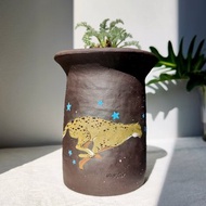 Running Cheetah and Hippo painted on black clay planter.