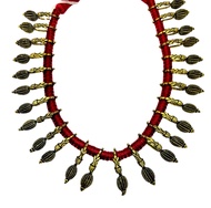 สร้อยคอชุบทอง Antique gold plated tribal collar necklace. Oxidized metal pieces are strung on a red