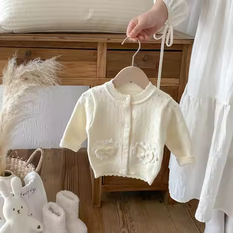 A long-sleeved cardigan with a bow and a hollowed-out small coat for girls in autumn and winter