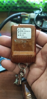 Tay điều khiển cửa cuốn Remote cửa cuốn mã nhảy 433 mhz YH vân gỗ