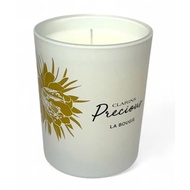 Cla Precious La Bougie candle with gold floral design.