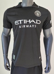 M.CITY Player issues 25/26 black jersey with Etihad Airways logo and Manchester City crest.