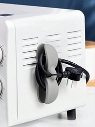 1個家用電器桌面電纜管理捲線器,配有插頭支架和電線夾子,能貼於牆面而不用釘子