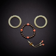 A string of eighteen qi'nan beads and a pair of celadon jade 'dragon' bangles, Qing dynasty, 19th ce