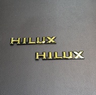 1คู่ HILUX  โลโก้ไฮลักษ ติดข้างแก้ม  สีทอง-ดำ โตโยต้า HILUX MIGHTY-X LN 85-111 SR-5 1989-1998