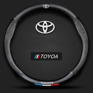 Toyota หุ้มพวงมาลัย หุ้มพวงมาลัยรถยนต์ ปลอกหนังหุ้มพวงมาลัยรถยนต์คาร์บอนไฟเบอร์ 38CM ซม. สําหรับ โตโยต้า ฝาครอบพวงมาลัย Toyota Allion Auris Wigo Hi Ace Avalon Aygo Vios Vitz Yaris Mark X Hilux Corolla Altis Axio Camry SA8411 ฟังก์ชั่นกันลื่น ช่วยเพิ่มความ