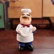 STATUE OF A CHEF HOLDING NOODLES