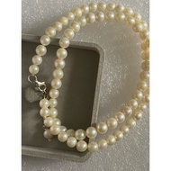 Creamy saltwater akoya pearl necklace with silver buckle.