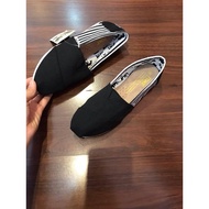 Black striped Toms shoes