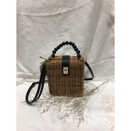 Rattan bag with pearl string handle