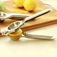 Shiny stainless steel lemon juice squeezer and squeezer
