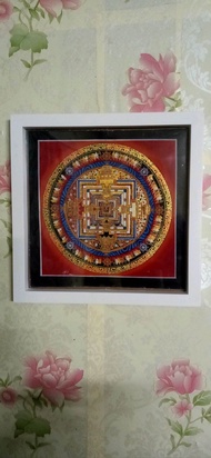 Tibetan potala (palace) thangka painting in frame.