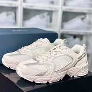 New Balance NB 530 sneakers for women in gray, beige, and white.